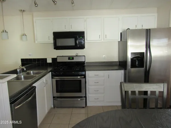 a kitchen with a sink and stainless steel appliances