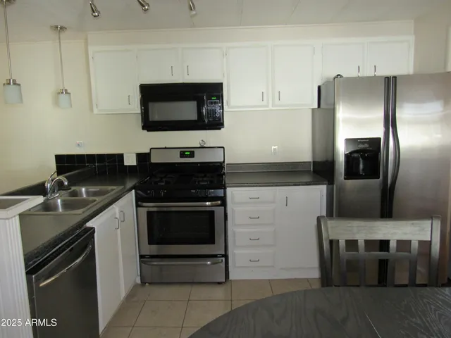 a kitchen with a sink and stainless steel appliances