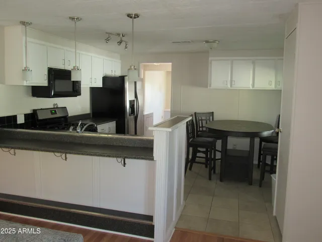 a kitchen with appliances cabinets and furniture