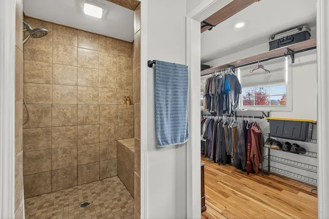 a view of a lake with a bench and trees around