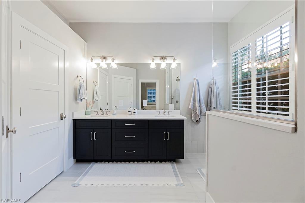 19013 Ridgepoint Drive Estero, FL 33928 - Photo 11 of 42 a bathroom with a sink vanity and a mirror