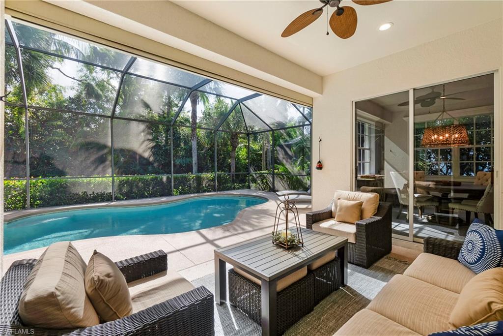 19013 Ridgepoint Drive Estero, FL 33928 - Photo 17 of 42 a living room with patio furniture and a yard