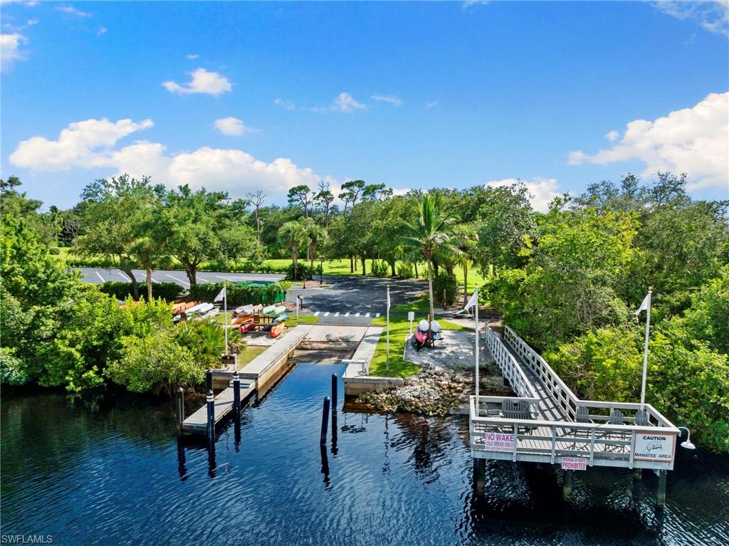 19013 Ridgepoint Drive Estero, FL 33928 - Photo 35 of 42 a backyard of a house with table and chairs