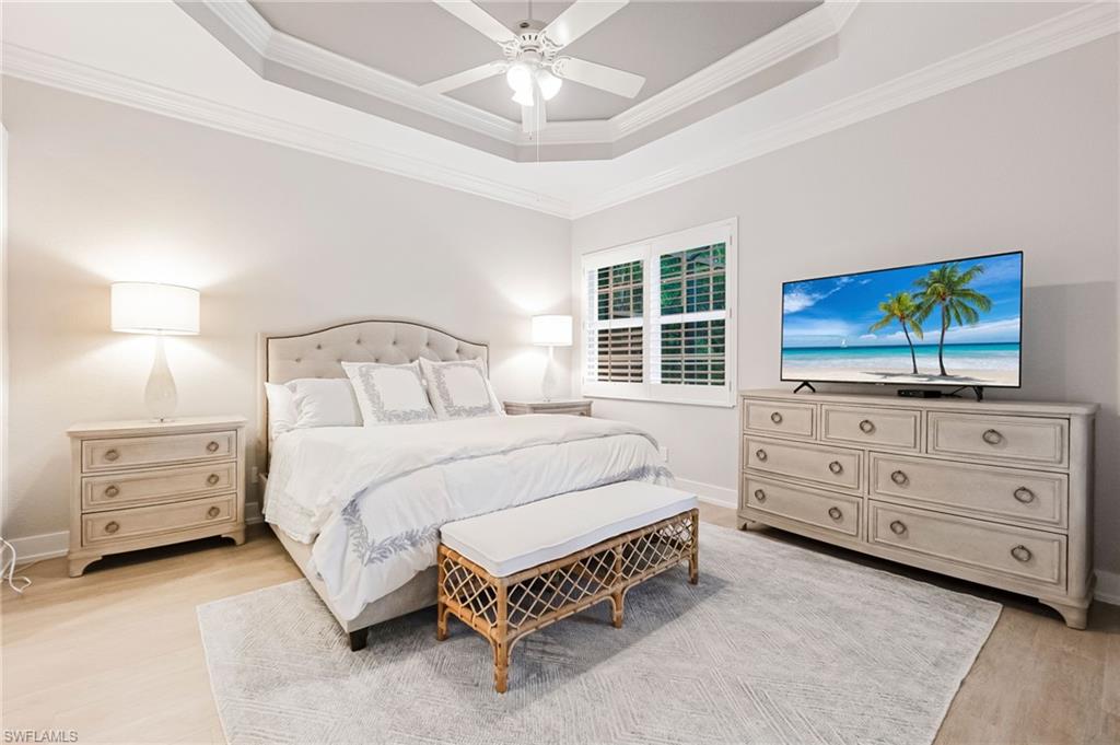 19013 Ridgepoint Drive Estero, FL 33928 - Photo 10 of 42 a bedroom with a bed and a flat tv screen on dresser