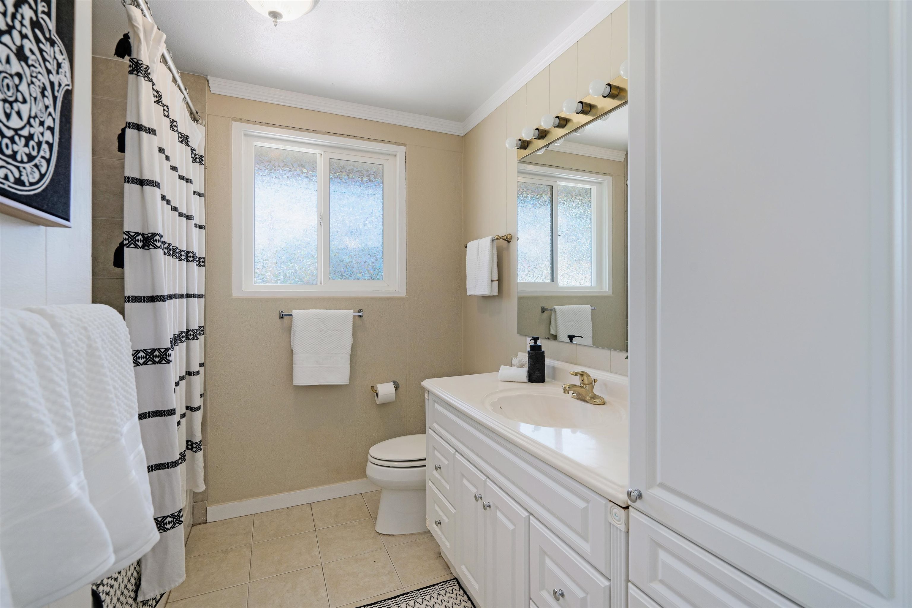 339 Manini Place Kihei, HI 96753 - Photo 12 of 34 a bathroom with a sink a toilet and shower