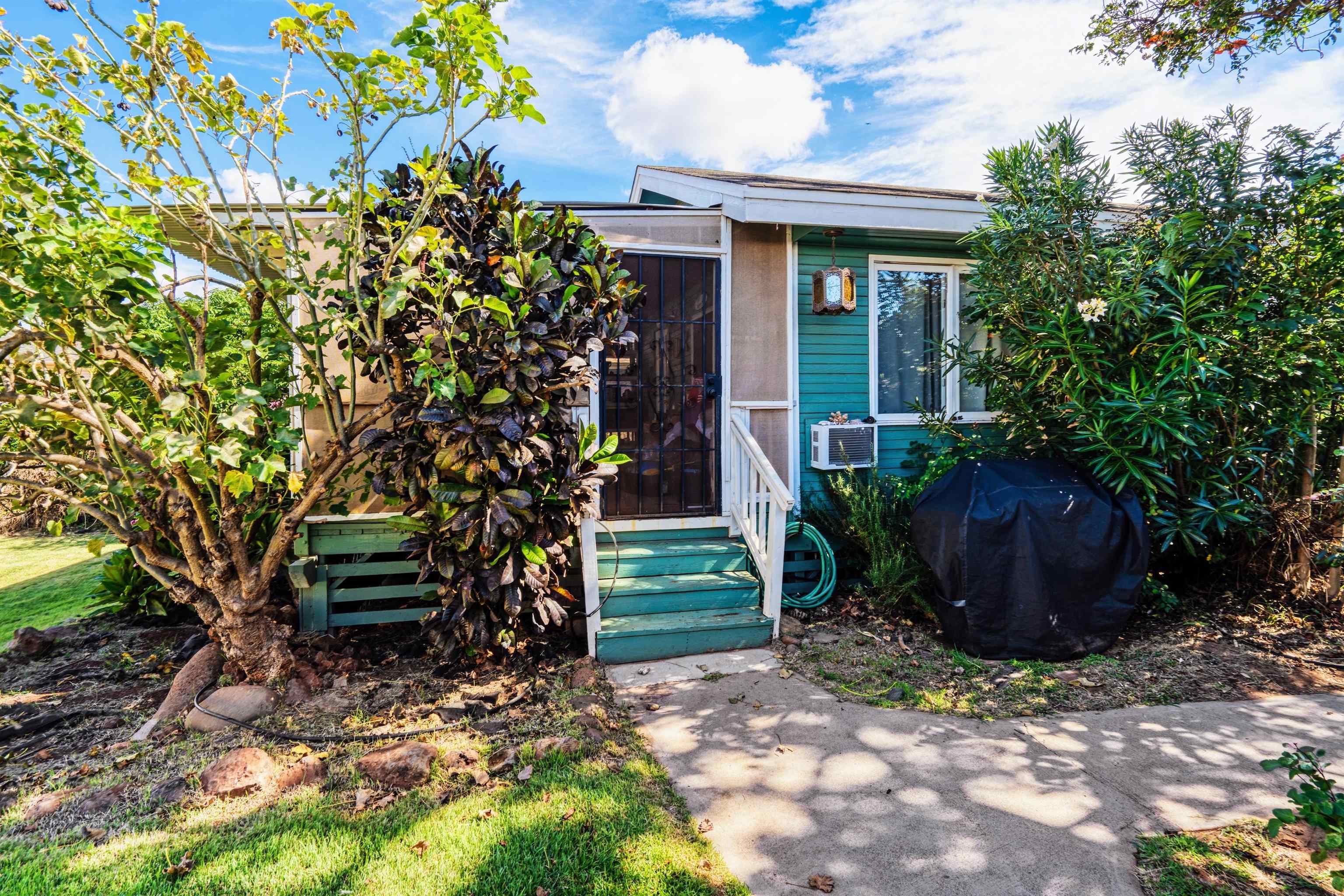 339 Manini Place Kihei, HI 96753 - Photo 24 of 34 a view of a backyard with plants and a garden