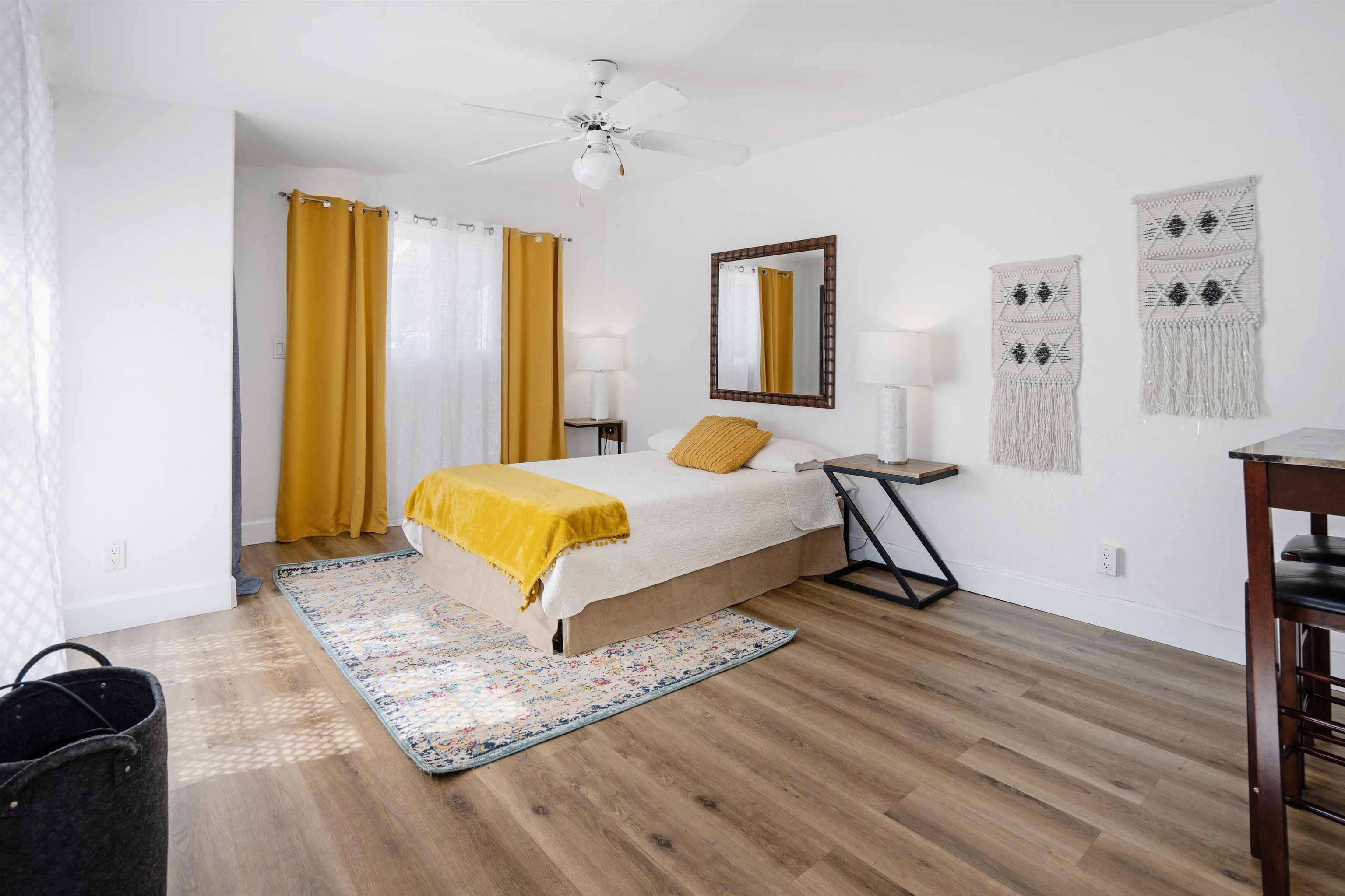 339 Manini Place Kihei, HI 96753 - Photo 27 of 34 a bedroom with a bed and wooden floor