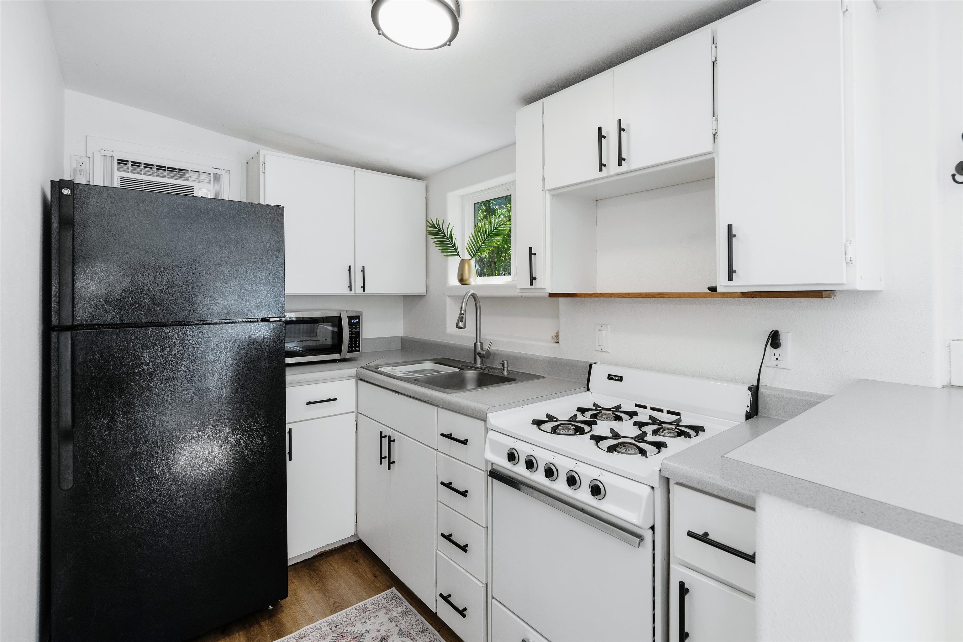 339 Manini Place Kihei, HI 96753 - Photo 29 of 34 a kitchen with a refrigerator and a stove top oven