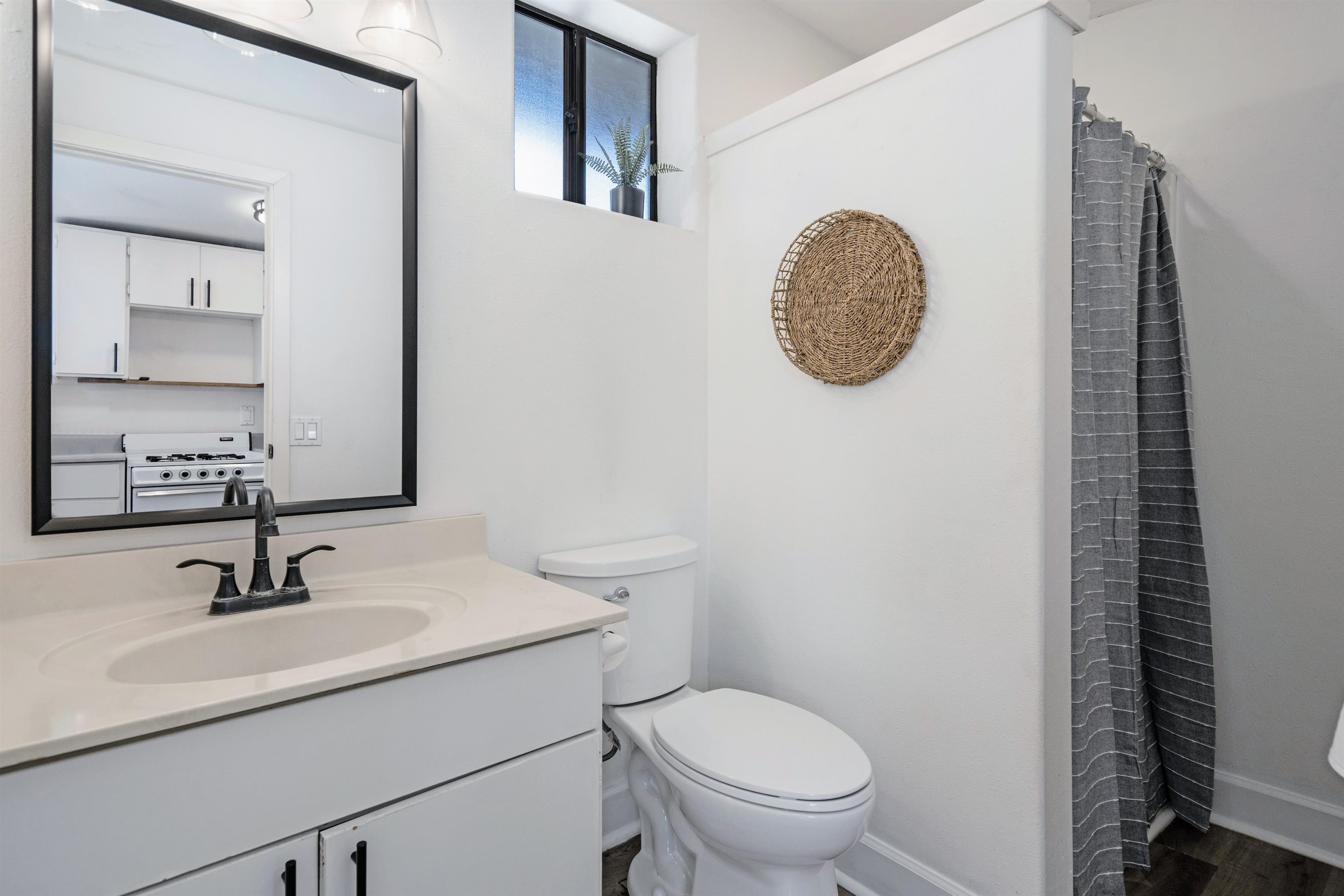 339 Manini Place Kihei, HI 96753 - Photo 30 of 34 a bathroom with a toilet sink and mirror