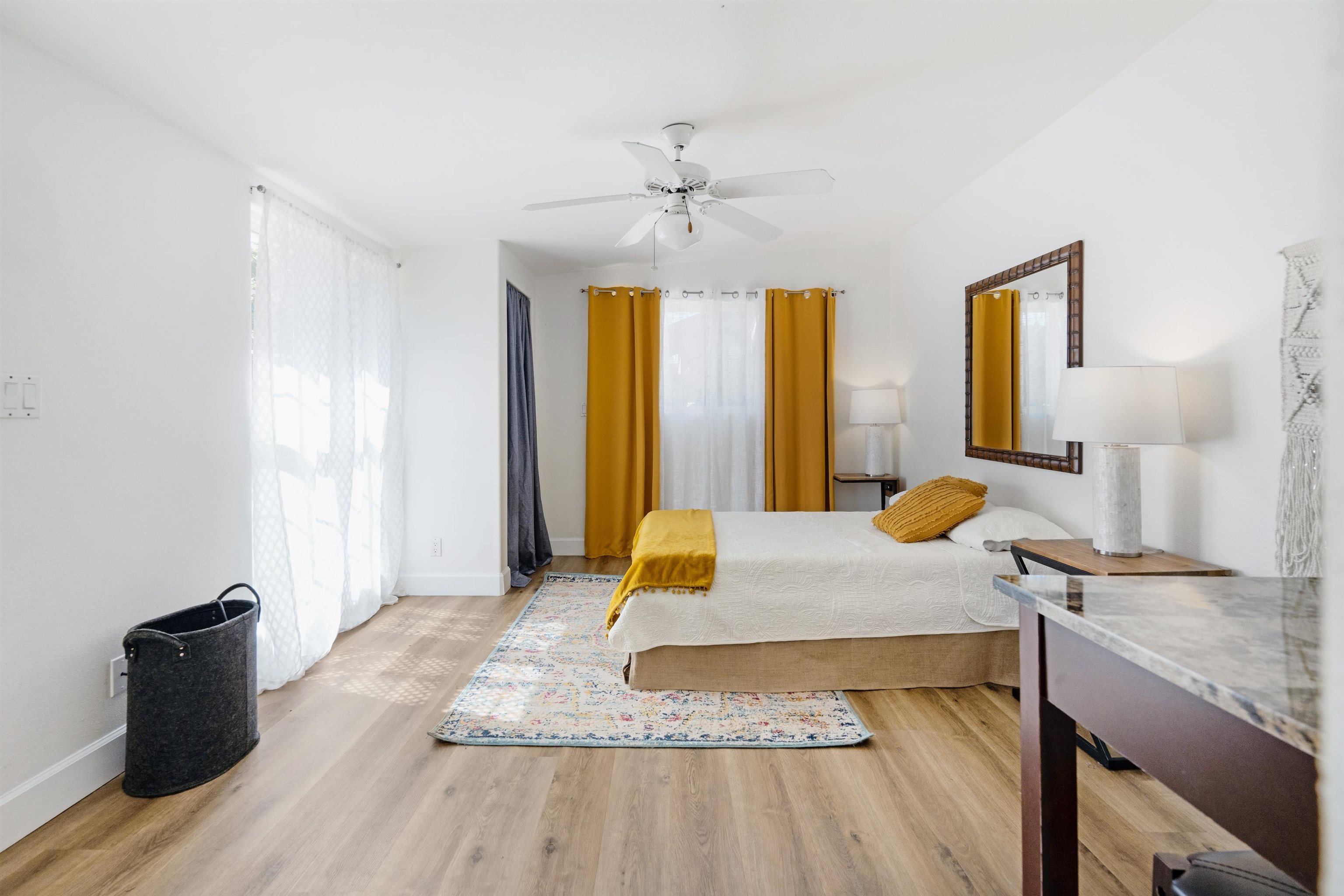 339 Manini Place Kihei, HI 96753 - Photo 31 of 34 a bedroom with a bed and wooden floor