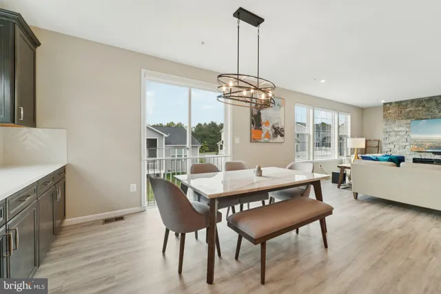 a view of a dining room with furniture wooden floor and chandelier