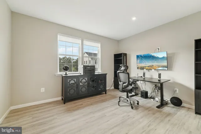 a view of a workspace with furniture and a window