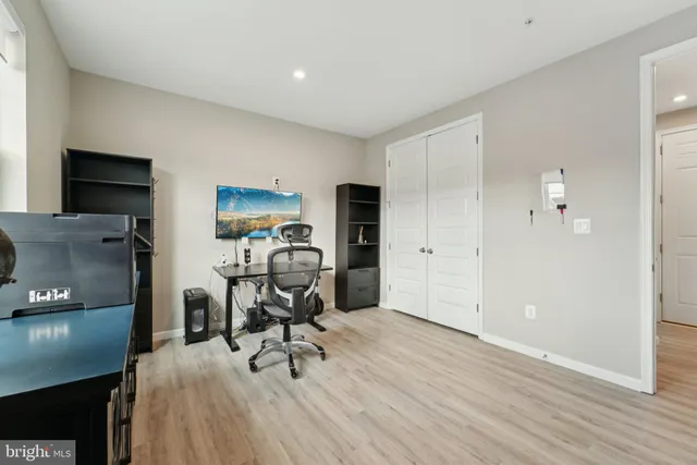 a view of a workspace with furniture and wooden floor