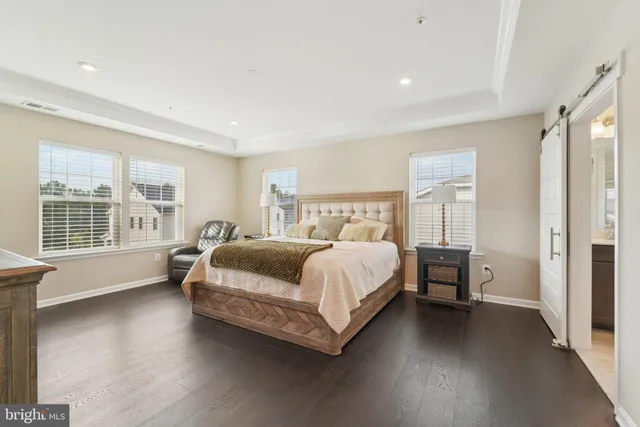 a spacious bedroom with a bed and a large window