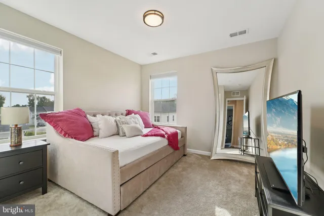 a bedroom with a bed and a couch