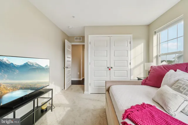 a bedroom with a bed and a couch