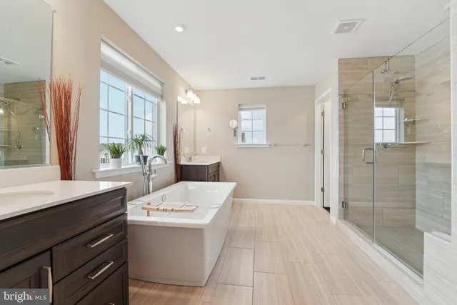 a room with a sink a window and a mirror