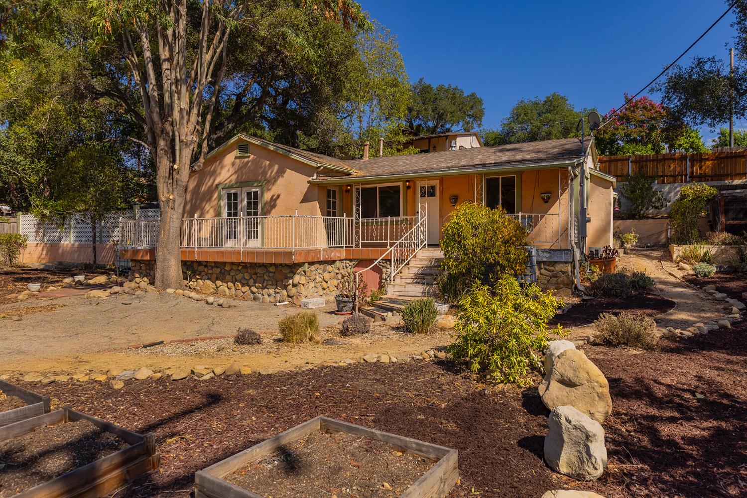a front view of a house with a yard covered with snow