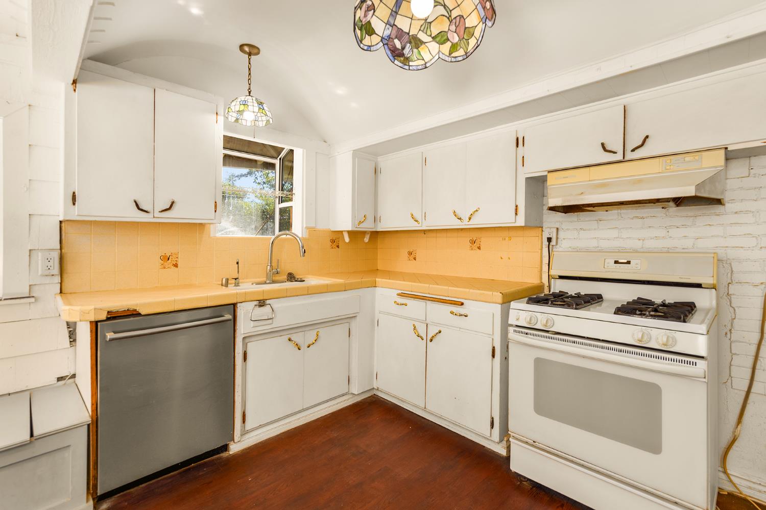228 High Street Oak View, CA 93022 - Photo 11 of 28 a kitchen with a stove sink and cabinets