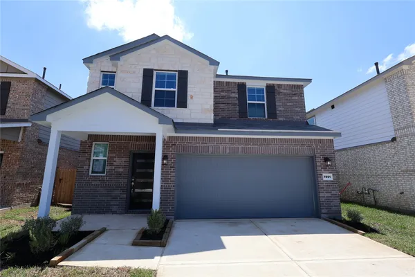 a front view of a house with garage