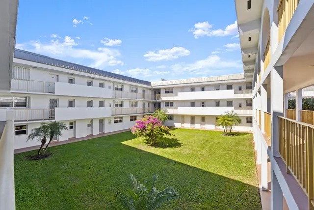 a view of an apartment with a swimming pool