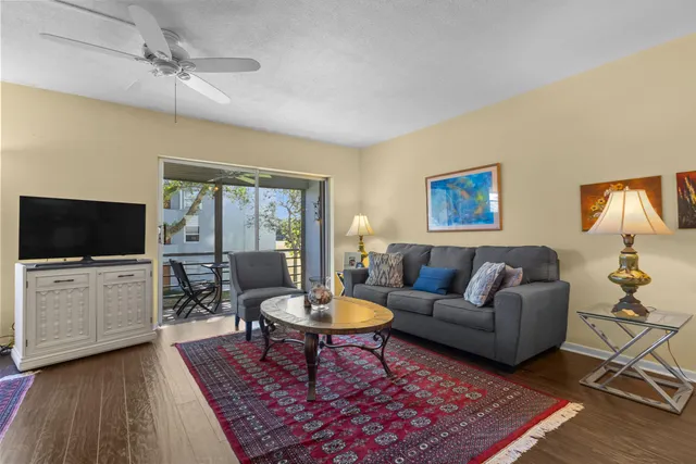 a living room with furniture a rug and a flat screen tv