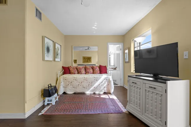 a bedroom with furniture and a flat screen tv