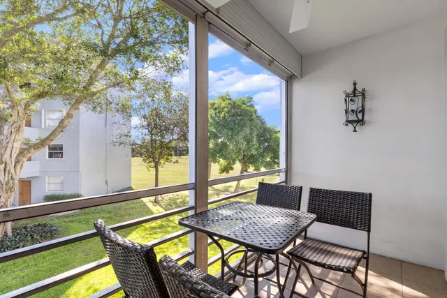 a view of a balcony with a table and chairs