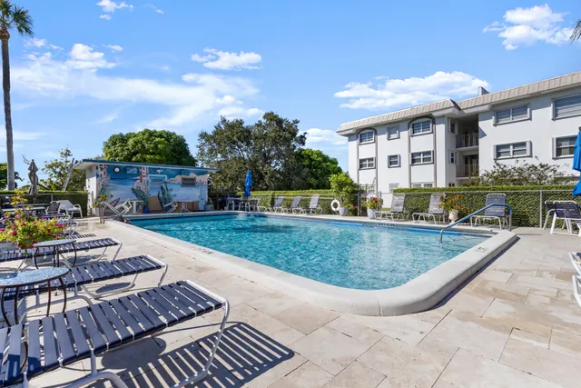 a view of a house with swimming pool and sitting area