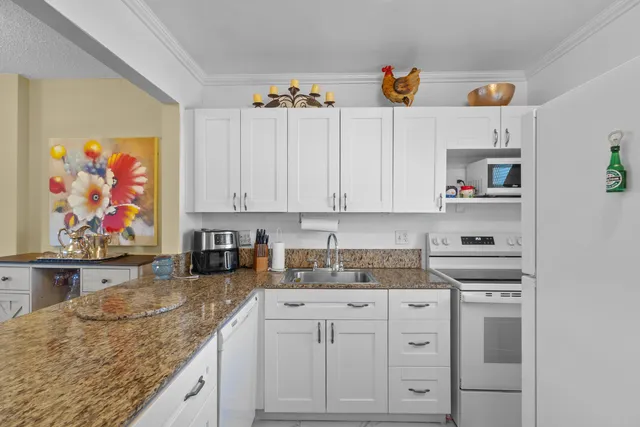 a kitchen with cabinets appliances and a counter top