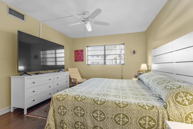 a bedroom with a bed and a flat screen tv in it