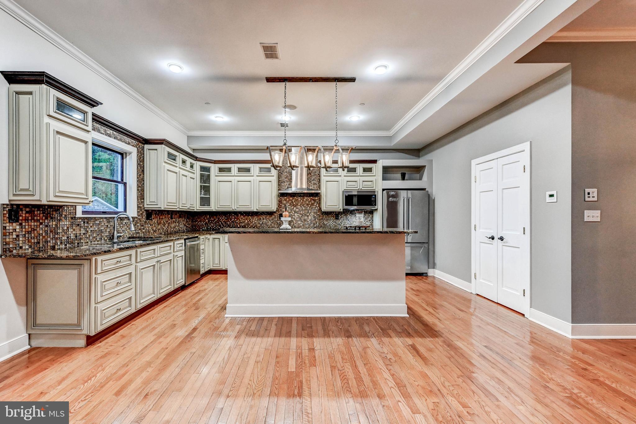 14412 Cuba Road Cockeysville, MD 21030 - Photo 12 of 35 a large kitchen with stainless steel appliances granite countertop a large center island and a wooden floors