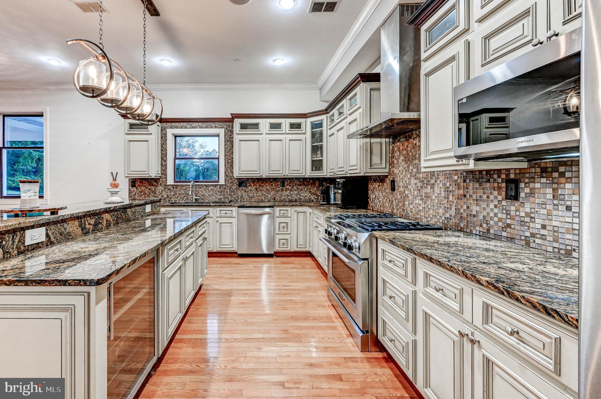 14412 Cuba Road Cockeysville, MD 21030 - Photo 9 of 35 a large kitchen with stainless steel appliances granite countertop a stove and a sink