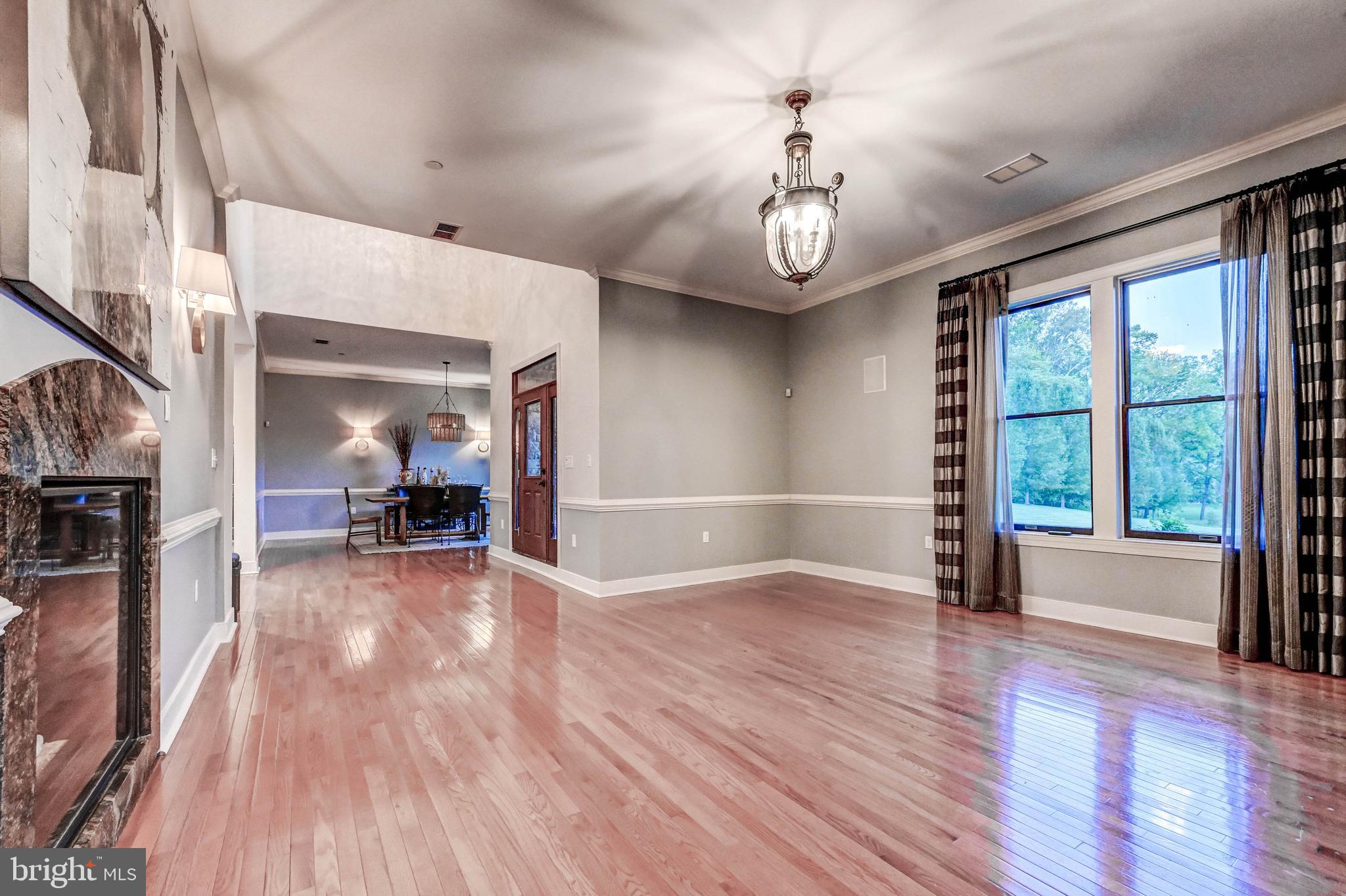 14412 Cuba Road Cockeysville, MD 21030 - Photo 10 of 35 an empty room with wooden floor fan and windows
