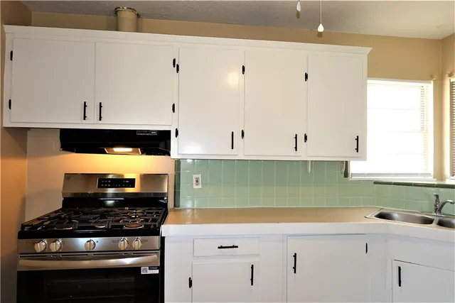 a kitchen with a sink and cabinets