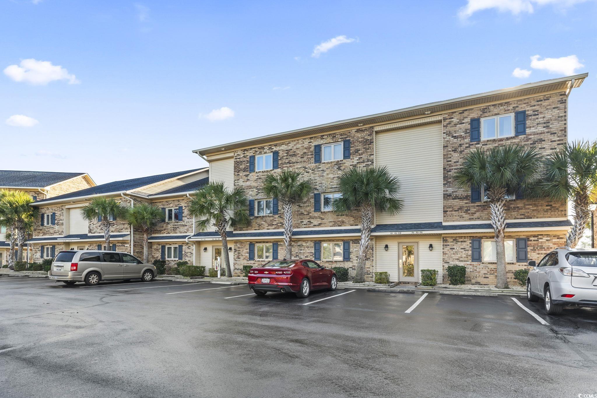 View of property with uncovered parking