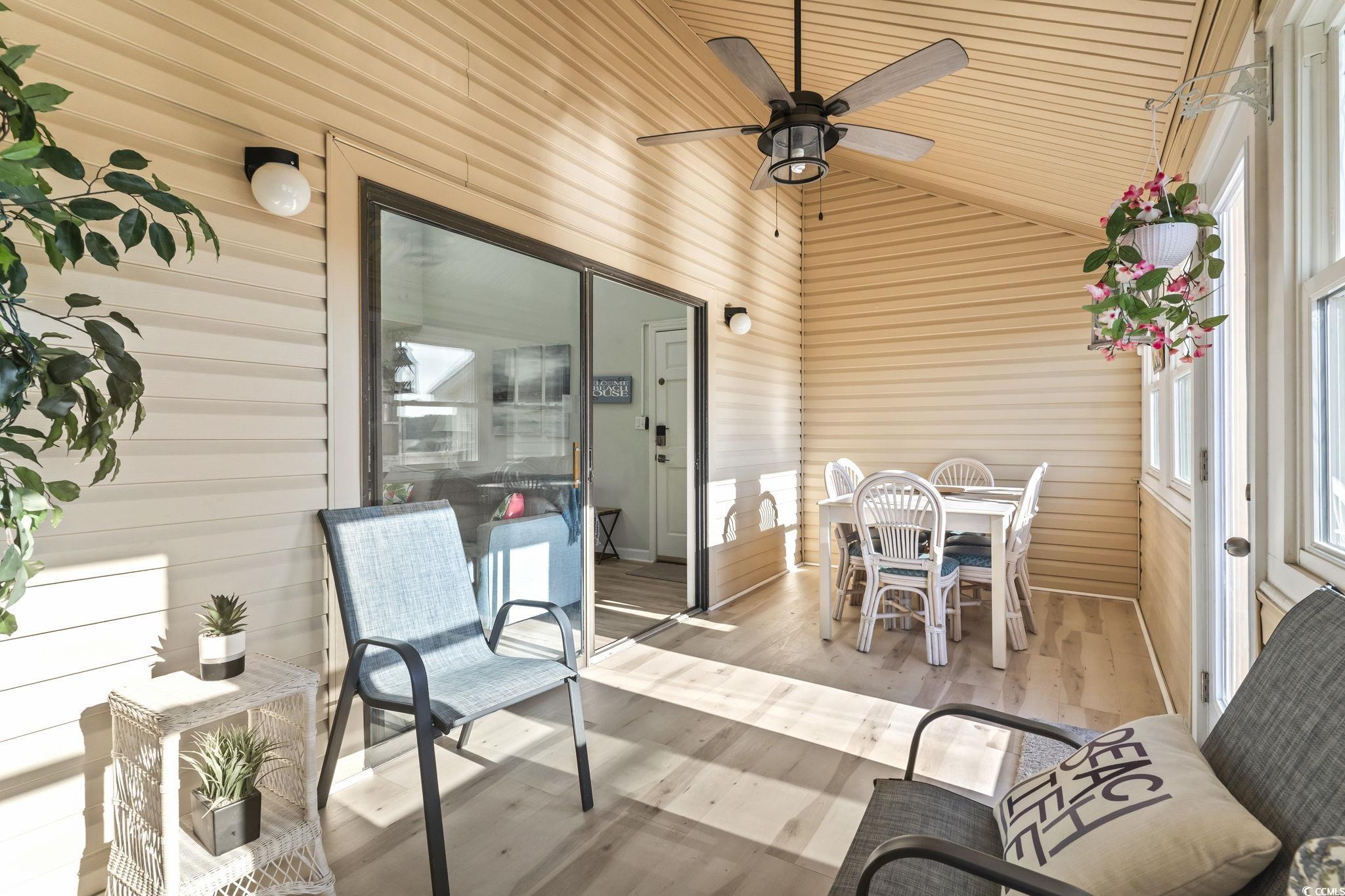 207 Double Eagle Drive, Unit F3 Myrtle Beach, SC 29575 - Photo 21 of 40 Sunroom featuring vaulted ceiling, ceiling fan, and outdoor dining area