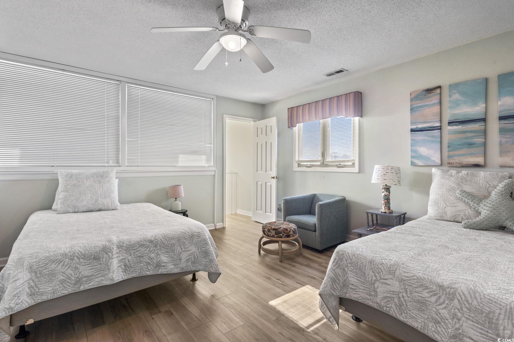 207 Double Eagle Drive, Unit F3 Myrtle Beach, SC 29575 - Photo 28 of 40 Bedroom featuring wood finished floors, a textured ceiling, and a ceiling fan