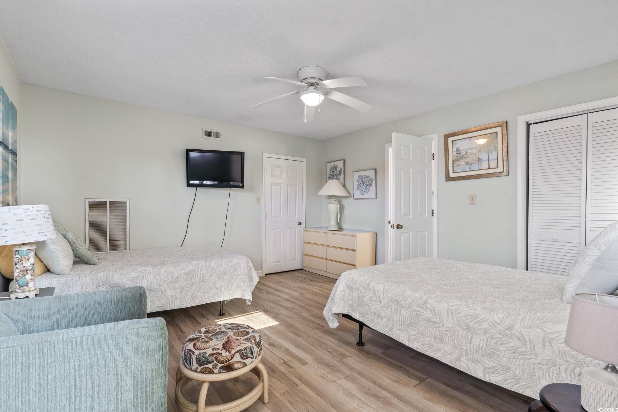 207 Double Eagle Drive, Unit F3 Myrtle Beach, SC 29575 - Photo 30 of 40 Bedroom with a closet, wood finished floors, and a ceiling fan