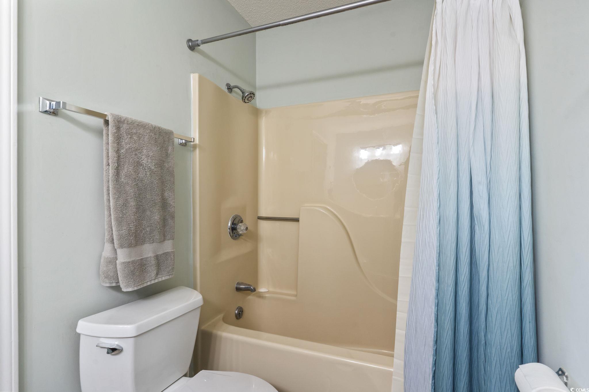 207 Double Eagle Drive, Unit F3 Myrtle Beach, SC 29575 - Photo 31 of 40 Full bath featuring shower / tub combo with curtain and toilet