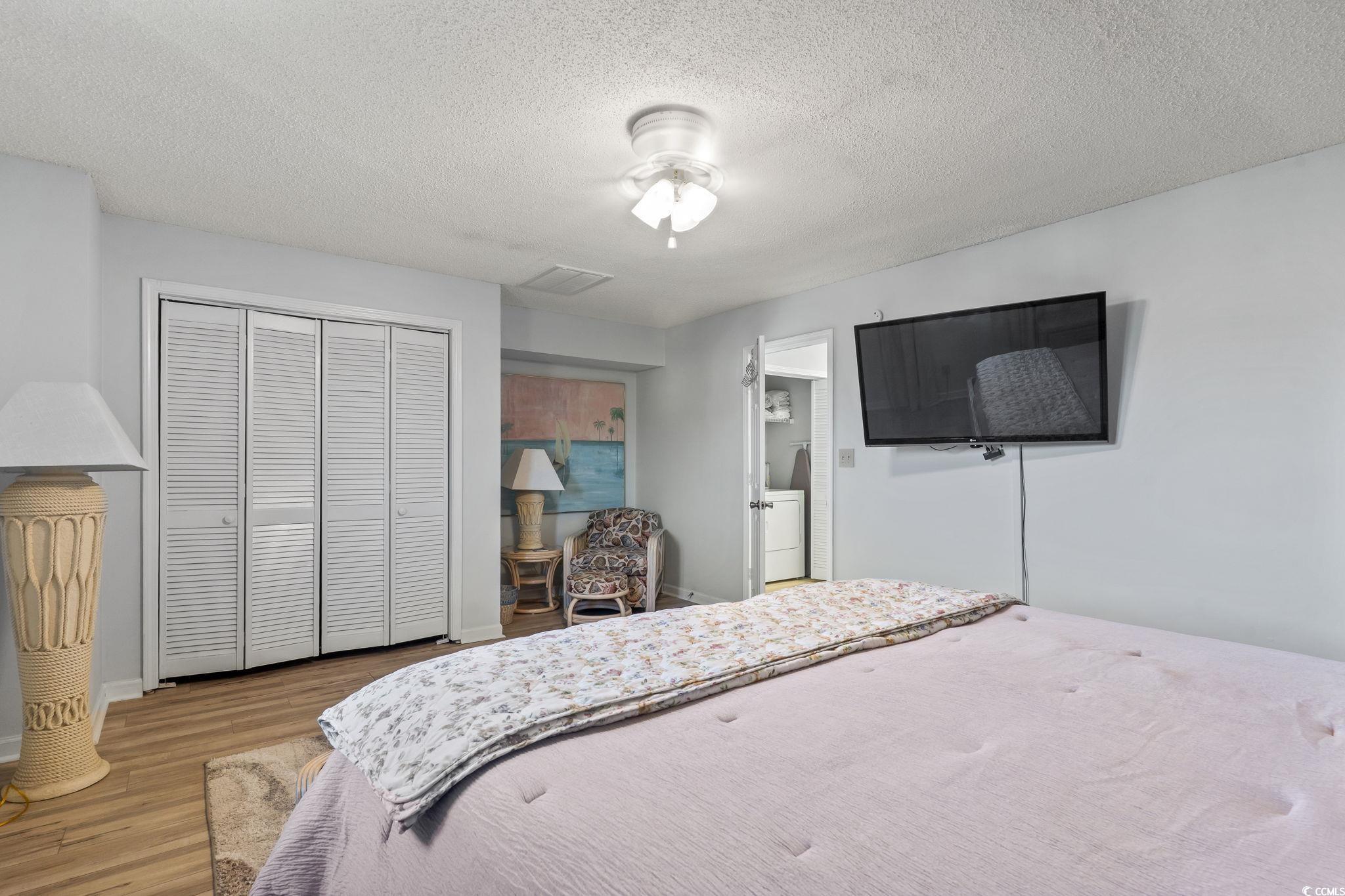 207 Double Eagle Drive, Unit F3 Myrtle Beach, SC 29575 - Photo 34 of 40 Bedroom with a textured ceiling, wood finished floors, and a closet