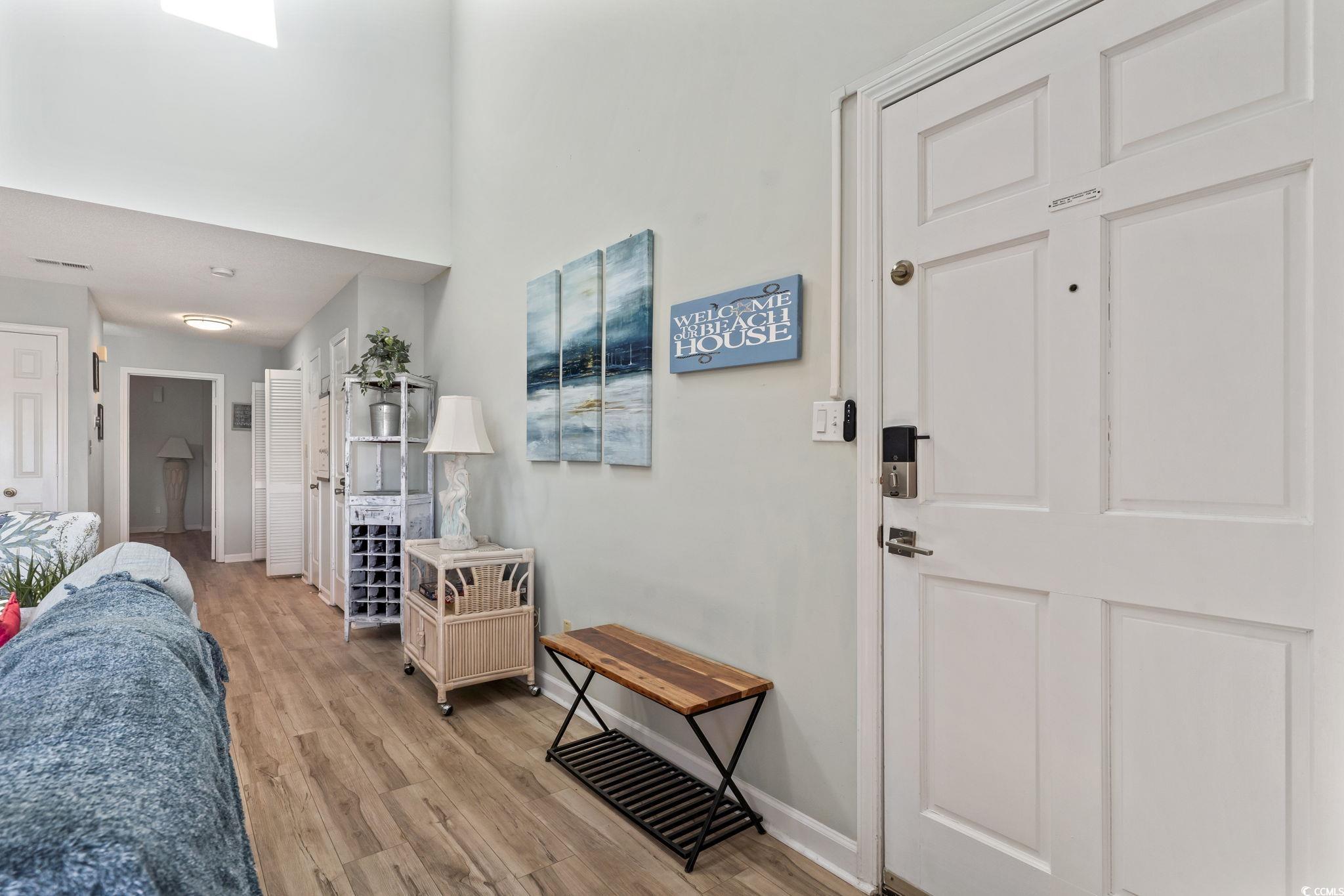 207 Double Eagle Drive, Unit F3 Myrtle Beach, SC 29575 - Photo 5 of 40 Foyer featuring light wood finished floors and a towering ceiling
