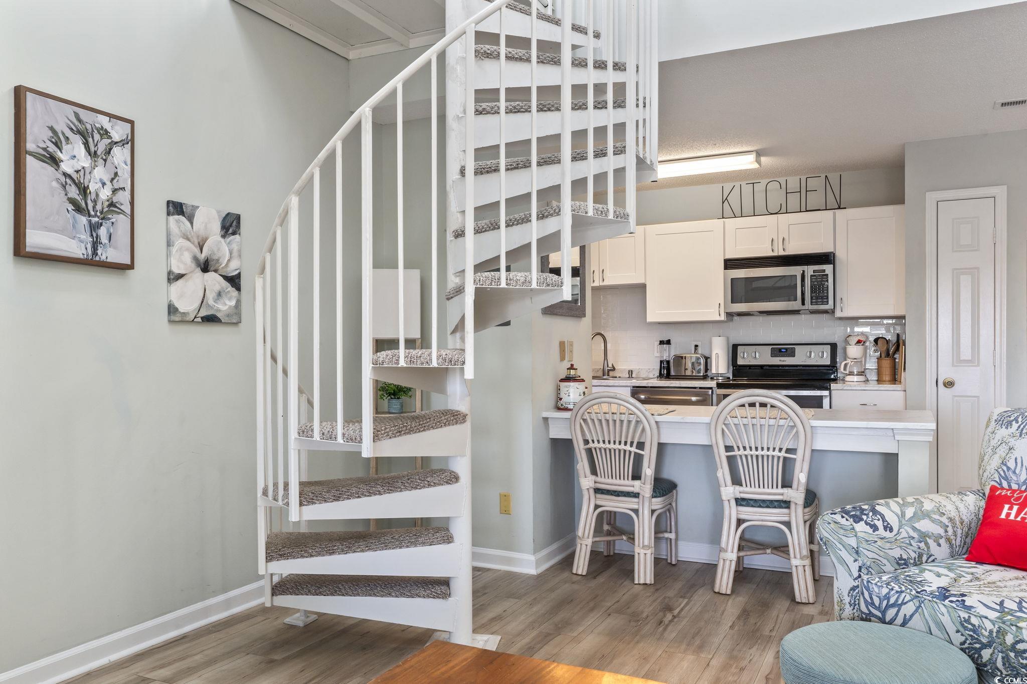 207 Double Eagle Drive, Unit F3 Myrtle Beach, SC 29575 - Photo 8 of 40 Stairs with wood finished floors and baseboards
