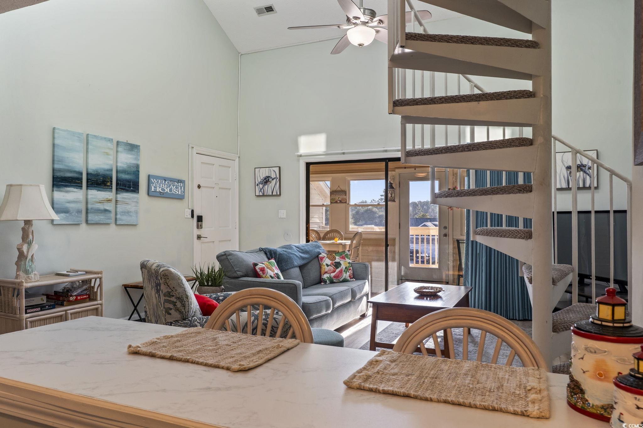 207 Double Eagle Drive, Unit F3 Myrtle Beach, SC 29575 - Photo 10 of 40 Dining room with ceiling fan, high vaulted ceiling, stairs, and wood finished floors