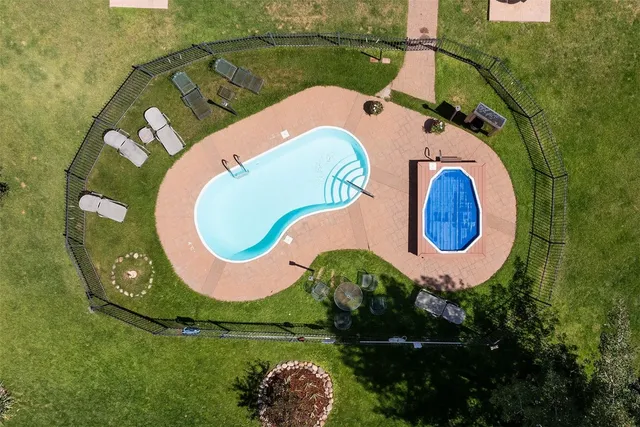 an aerial view of a house with swimming pool and outdoor space