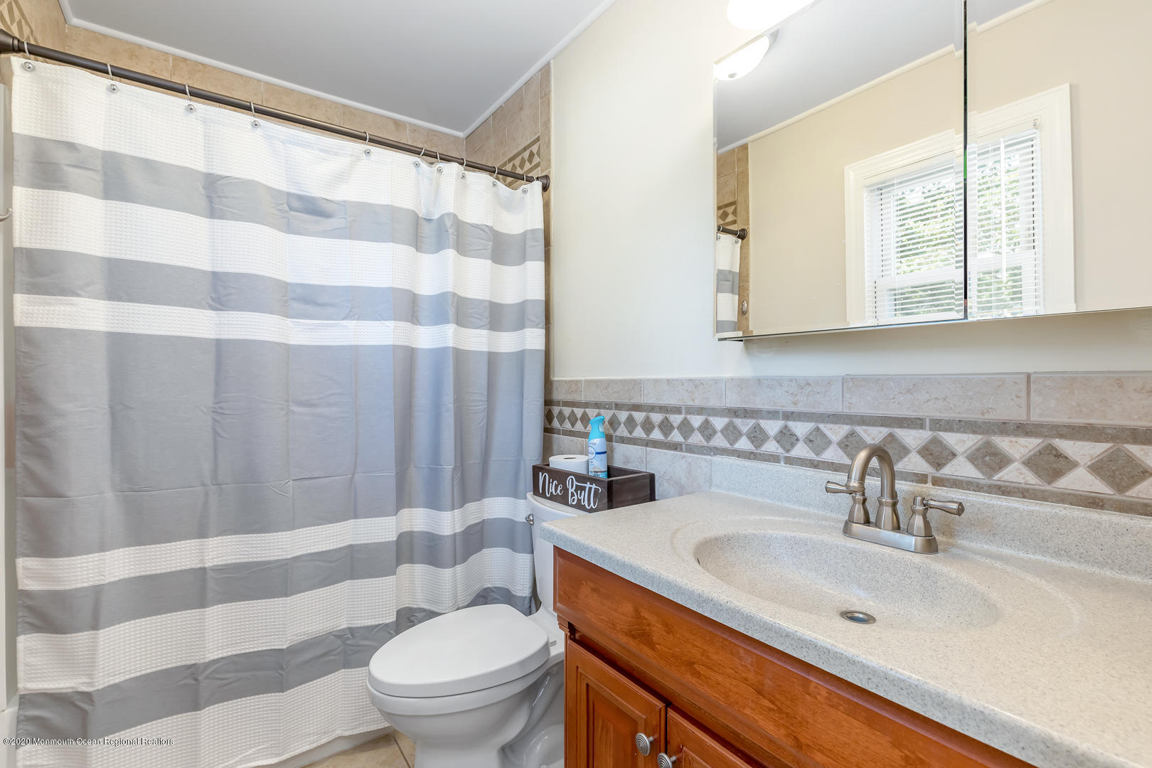 74 Pineland Road Brick, NJ 08724 - Photo 18 of 38 a bathroom with a sink a toilet a mirror and shower curtain