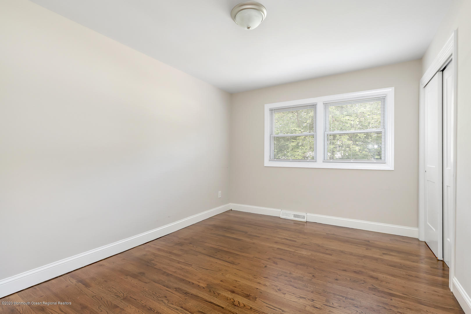 74 Pineland Road Brick, NJ 08724 - Photo 19 of 38 an empty room with wooden floor and windows