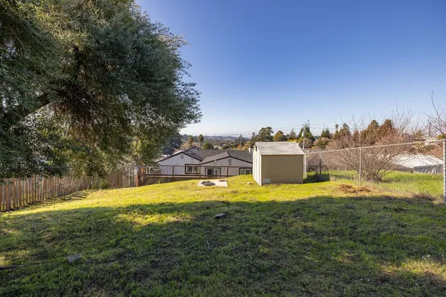 a swimming pool with trees in front of it