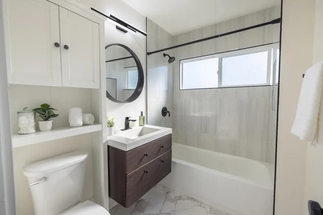 a bathroom with a sink a toilet and a mirror