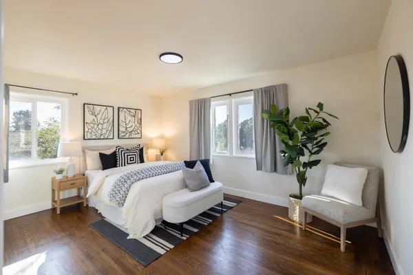 a bed room with a bed and a chair